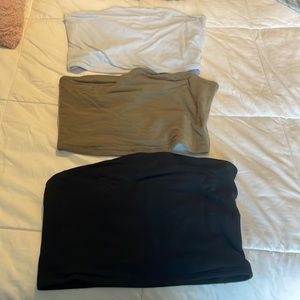 Three black, green, and blue tube tops